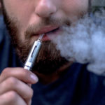 Man Exhaling Vapour from E-Cigarette